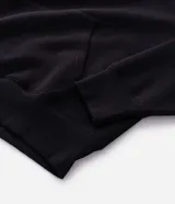 Buzo tipo canguro de color gris melange, con capucha, bolsillo canguro frontal y puños y bajo acanalados. Corte recto.