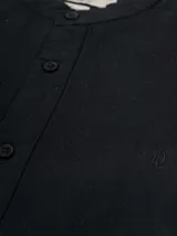 Camisa de manga larga color crudo, confeccionada en lino. Presenta cuello mao y cierre frontal con botones. Marca La Dolphina.