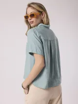 Camisa blanca de manga corta con cuello clásico y bolsillo en el pecho. Confeccionada en lino y viscosa.