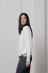 Sweater negro de punto con mangas largas y paneles de lentejuelas plateadas en los hombros y brazos.