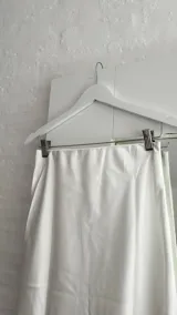 Pollera larga color blanco de seda con elástico en la cintura.