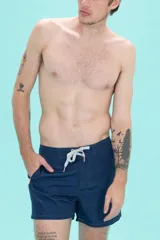 Short de baño azul marino con cintura fija, bolsillo lateral con cierre y cordón bicolor.