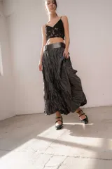 Pollera larga color beige con textura arrugada y abertura frontal.