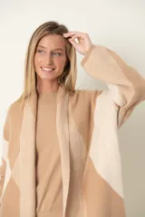 Saco largo de punto con estampado de rombos, corte suelto y textura suave.