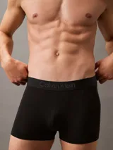 Pack de tres bóxers ajustados Calvin Klein, uno negro, uno gris y uno azul marino, con cintura elástica con logo de la marca.