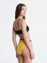 Bombacha de algodón color amarillo con cintura alta y elástico negro con logo Calvin Klein.