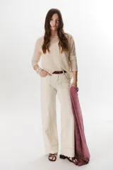 Pantalón negro de corte recto, pierna ancha y tiro alto, con detalles de pespuntes blancos a contratono.