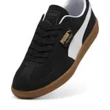 Championes Puma Palermo negros con detalles en blanco y suela color caramelo.