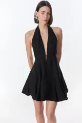 Vestido corto fucsia con escote halter y espalda descubierta.