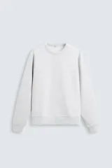 Sudadera gris claro de cuello redondo y manga larga, corte relaxed fit y terminaciones en rib.