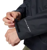 Campera impermeable Columbia Watertight II para hombre, color negro, con capucha ajustable, cierre frontal con cremallera, bolsillos laterales con cremallera, puños ajustables con velcro y dobladillo ajustable con cordón. Logo de Columbia estampado en el pecho. Se guarda en su propio bolsillo.