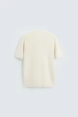 Camiseta negra de corte recto y manga corta, tejida en punto perlado de algodón.