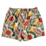 Short de baño con estampado de hojas de palmera y círculos rojos.