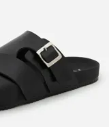 Sandalia slide city negra de material sintético, con tiras cruzadas y hebilla ajustable.