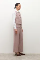 Pantalón de tiro alto, corte ancho y largo, con estampado de pata de gallo pequeño en tonos beige y rosado/marrón. Presenta bolsillos delanteros con solapa.