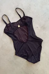 Malla enteriza negra entallada con ganchito en la espalda para cerrar. Espalda descubierta y bottom ancho.