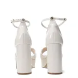 Sandalias de cuero negro con plataforma y tacón ancho, tiras cruzadas en el empeine y pulsera con hebilla al tobillo.