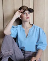 Gorra tipo visera de cuero color celeste, talle único ajustable.