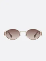 Lentes de sol con montura dorada de metal y lentes marrones degradé con forma ovalada.