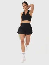 Falda corta deportiva negra con calza incorporada y tablas plisadas.