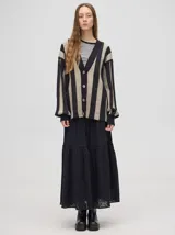 Falda larga blanca de broderie de algodón con detalle de galones con transparencias, pretina elástica con cordones ajustables y forro jacquard.