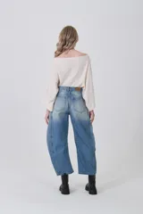 Pantalón de jean gris oscuro, de corte barrel, con bolsillos laterales y traseros, pinzas y tiro medio.