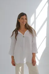 Camisa blanca de lino con mangas 3/4 y un botón grande.