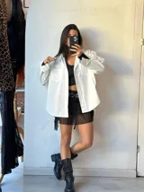 Camisa blanca de manga larga con cuello clásico y botones frontales.