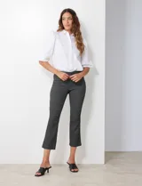 Pantalón negro con estampado geométrico blanco, de corte flare y pretina ancha elastizada.