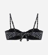 Top de bikini negro con estampado de lunares blancos, corte media taza con breteles ajustables y lazo en la espalda. Confeccionado en microfibra.