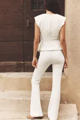 Pantalón negro de tiro alto confeccionado en tejido de punto elástico y flexible con trama compacta, mullida y opaca. Bajo acampanado.