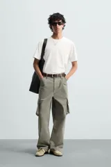 Pantalón cargo de algodón color verde oliva, corte regular fit, con bolsillos laterales con fuelle y solapa, y efecto lavado.