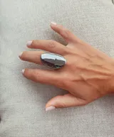 Anillo plateado grande con forma ovalada.