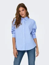 Camisa celeste a rayas verticales blancas, de corte clásico, manga larga con puños abotonados y cuello camisero.