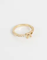 Anillo dorado con strass y un moño de metal.