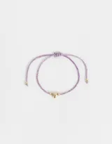 Pulsera de cordón ajustable color lila con dije de corazón dorado.