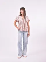 Blusa estampada con cuello en V y mangas cortas con volados.