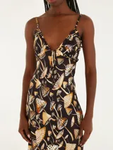 Vestido largo con estampado de hongos en tonos negro, beige y naranja, con tirantes delgados y escote en V profundo.