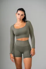 Remera deportiva color verde militar, de corte cropped y mangas largas.
