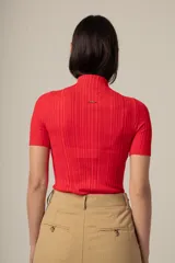 Camiseta roja de tejido de punto acanalado, con cuello alto y mangas cortas.