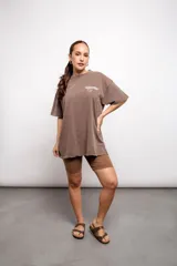 Remera marrón de corte holgado con estampado frontal de texto.