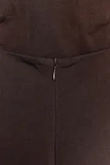 Vestido midi marrón con cuello halter y tirantes finos. Presenta detalle de tejido drapeado y cierre con cremallera oculta en la costura.
