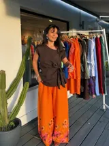 Pantalón palazzo color fucsia con estampado floral en el ruedo.