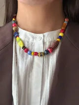Collar corto con cuentas de cristal checo, cerámica, madera y otros materiales. Se cierra con cadena y ganchito para regular el largo.