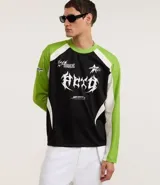 Remera de poliéster negra con mangas raglán verde lima y detalles blancos en los hombros. Presenta estampados con tipografías y gráficos en blanco en el frente.