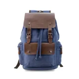 Mochila negra de tela canvas con detalles en símil cuero marrón, cierre superior marinero, bolsillos internos y externos con cierre metálico, asas rígidas y correas ajustables.