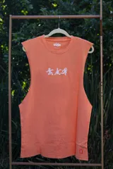 Musculosa color salmón con cuello redondo y estampado frontal con diseño abstracto en blanco.