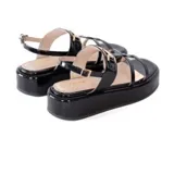 Sandalias negras de charol con plataforma de 5 cm, tiras frontales y pulsera ajustable al tobillo con detalle metálico dorado.