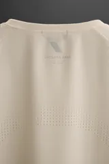 Camiseta deportiva marrón de tejido técnico, ligero y elástico con perforaciones. Cuello redondo, manga corta y logo estampado.