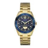 Reloj Guess Moonstruck con caja dorada de acero inoxidable, esfera azul con subesferas multifunción y correa de eslabones dorada.